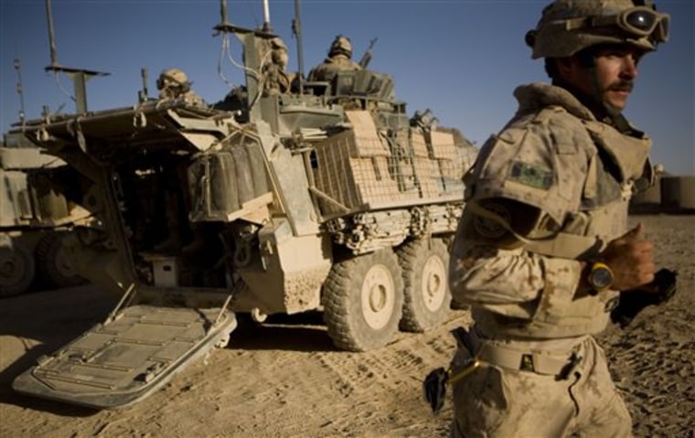 A Canadian soldier with the 1st Battalion, The Royal Canadian Regiment, rushes as he leave to rescue injured comrades who where involved in an IED attack in the Panjwayi district, south-west of Kandahar, Afghanistan, on Sunday. 